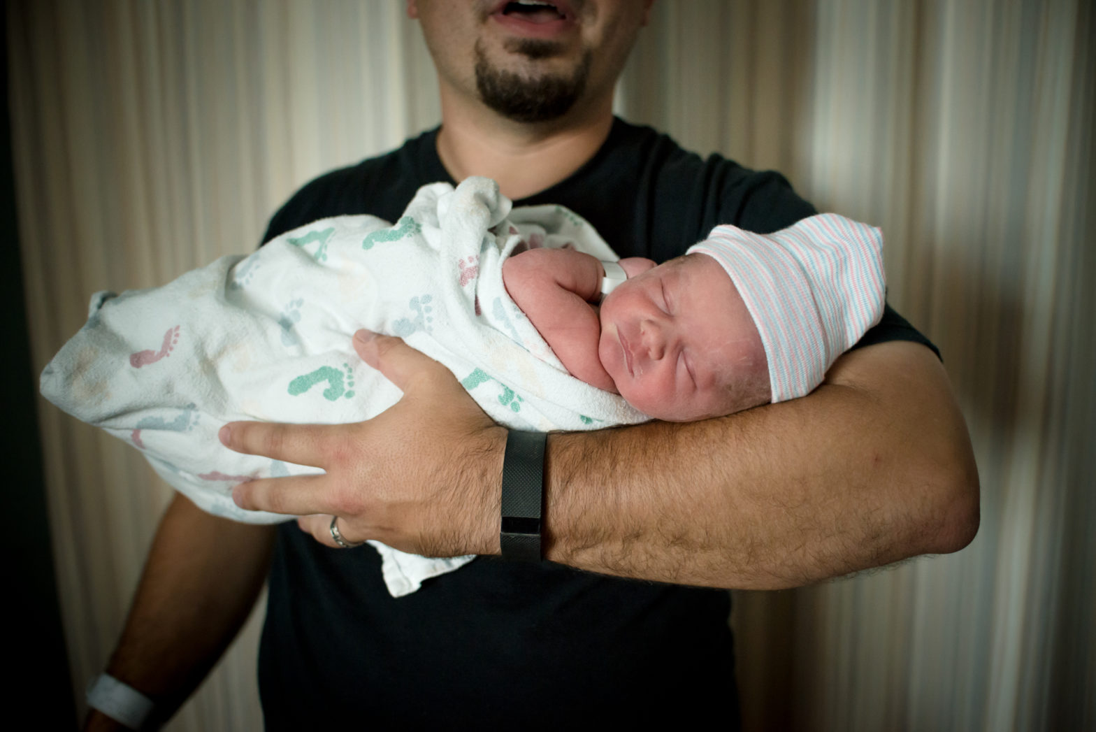 first time dad holding his new baby girl