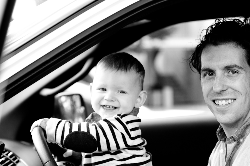 building relationship between a dad and his son by pretending to drive his car while still small enough tosit on his lap.